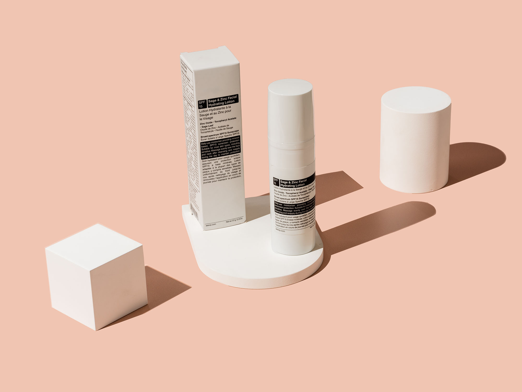 Sleek skincare products captured by professional eCommerce photography in Los Angeles, showcasing a minimalist design with crisp white packaging on a pastel peach background, evoking the clean, modern aesthetic of online retail excellence.